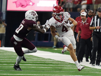 Arkansas Razorbacks wide receiver Isaac TeSlaa #4 rushes with the ball against the Texas A&M Aggies during the Southwest Classic match betwe...