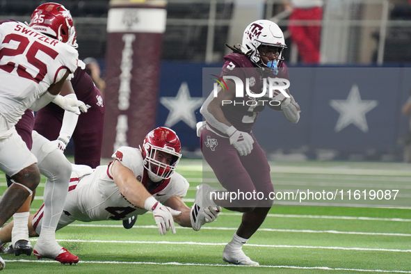 Texas A&M Aggies running back Amari Daniels #5 rushes with the ball against the Arkansas Razorbacks during the Southwest Classic match betwe...