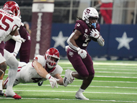 Texas A&M Aggies running back Amari Daniels #5 rushes with the ball against the Arkansas Razorbacks during the Southwest Classic match betwe...