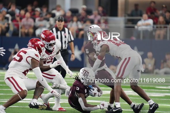 Texas A&M Aggies running back Amari Daniels #5 rushes with the ball against the Arkansas Razorbacks during the Southwest Classic match betwe...