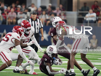 Texas A&M Aggies running back Amari Daniels #5 rushes with the ball against the Arkansas Razorbacks during the Southwest Classic match betwe...