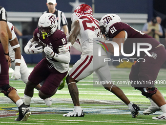 Texas A&M Aggies running back Le'Veon Moss #8 runs with the ball against the Arkansas Razorbacks during the Southwest Classic match between...