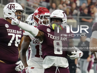 Texas A&M Aggies running back Le'Veon Moss #8 celebrates against the Arkansas Razorbacks during the Southwest Classic match between the Arka...