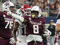 Texas A&M Aggies running back Le'Veon Moss #8 celebrates against the Arkansas Razorbacks during the Southwest Classic match between the Arka...