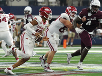 Arkansas Razorbacks quarterback Taylen Green #10 rushes with the ball against Texas A&M Aggies during the Southwest Classic match between th...