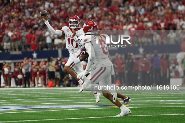 Arkansas Razorbacks quarterback Taylen Green #10 rolls the puck to pass the ball against Texas A&M Aggies during the Southwest Classic match...