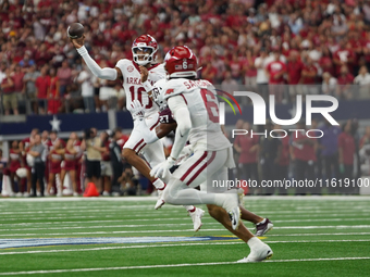 Arkansas Razorbacks quarterback Taylen Green #10 rolls the puck to pass the ball against Texas A&M Aggies during the Southwest Classic match...