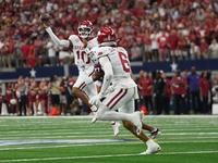 Arkansas Razorbacks quarterback Taylen Green #10 rolls the puck to pass the ball against Texas A&M Aggies during the Southwest Classic match...