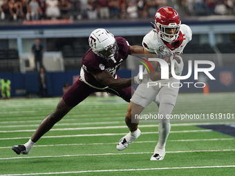 Arkansas Razorbacks Wide Receiver Isaiah Sategna #6 catches the ball against Texas A&M Razorbacks during the Southwest Classic match between...