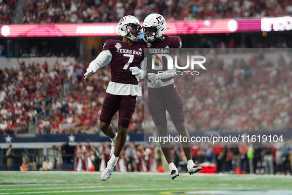 Texas A&M Aggies Moose #7 and Jahdae Walker #9 celebrate after a touchdown against the Arkansas Razorbacks during the Southwest Classic matc...