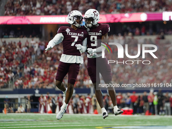 Texas A&M Aggies Moose #7 and Jahdae Walker #9 celebrate after a touchdown against the Arkansas Razorbacks during the Southwest Classic matc...