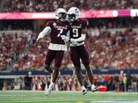 Texas A&M Aggies Moose #7 and Jahdae Walker #9 celebrate after a touchdown against the Arkansas Razorbacks during the Southwest Classic matc...