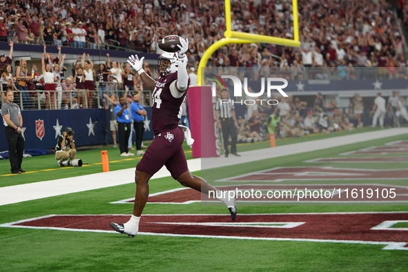 Texas A&M Aggies tight end Tre Watson #84 scores a touchdown against the Arkansas Razorbacks during the Southwest Classic match between the...