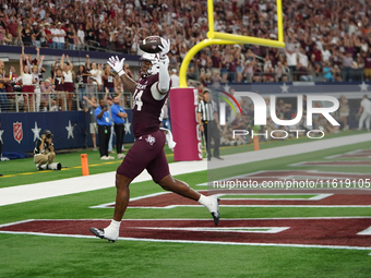 Texas A&M Aggies tight end Tre Watson #84 scores a touchdown against the Arkansas Razorbacks during the Southwest Classic match between the...