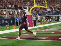 Texas A&M Aggies tight end Tre Watson #84 scores a touchdown against the Arkansas Razorbacks during the Southwest Classic match between the...