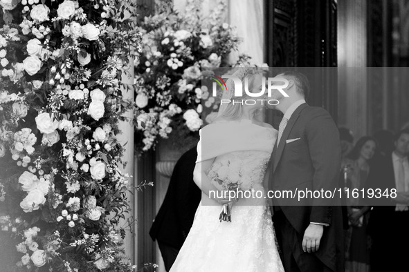 Princess Theodora Glucksburg of Greece and Matthew Jeremiah Kumar kiss each other after their wedding at the Metropolitan Cathedral in Athen...