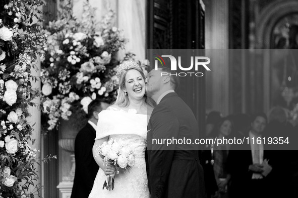 Matthew Jeremiah Kumar kisses Princess Theodora Glucksburg of Greece on her neck after their wedding at the Metropolitan Cathedral in Athens...