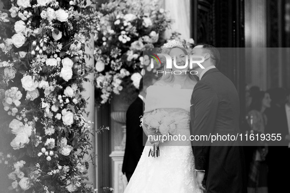 Matthew Jeremiah Kumar kisses Princess Theodora Glucksburg of Greece on her neck after their wedding at the Metropolitan Cathedral in Athens...