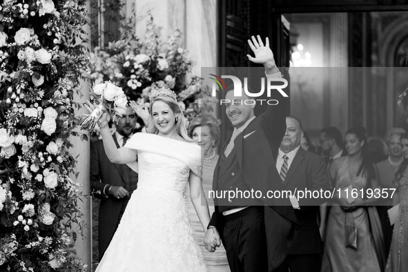 Princess Theodora Glucksburg of Greece and Matthew Jeremiah Kumar greet after their wedding at the Metropolitan Cathedral in Athens, Greece,...