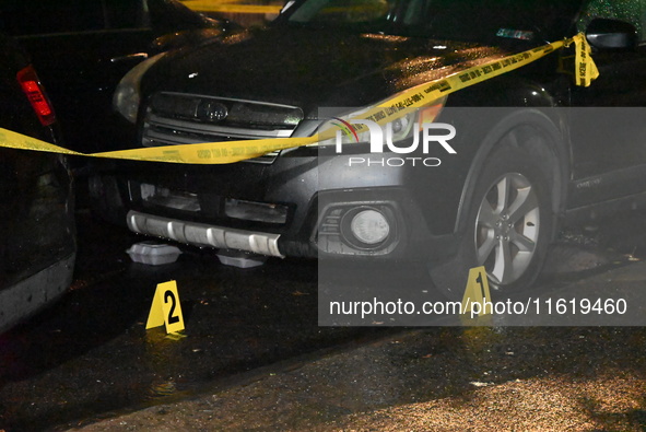 Evidence markers mark the scene where one man is killed and one man is injured in a shooting in the Kingsbridge Heights section of the Bronx...