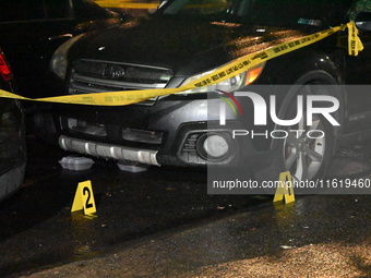 Evidence markers mark the scene where one man is killed and one man is injured in a shooting in the Kingsbridge Heights section of the Bronx...