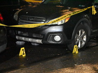 Evidence markers mark the scene where one man is killed and one man is injured in a shooting in the Kingsbridge Heights section of the Bronx...