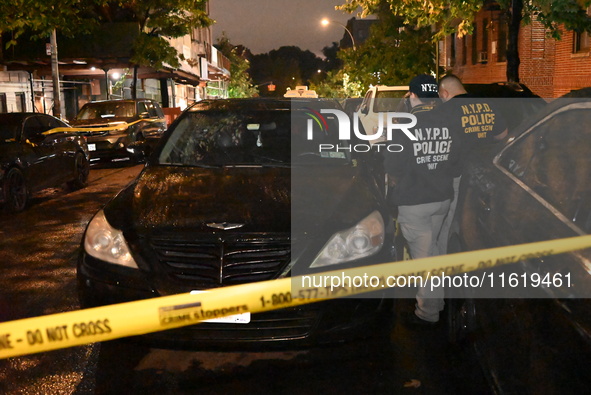 Evidence markers mark the scene where one man is killed and one man is injured in a shooting in the Kingsbridge Heights section of the Bronx...