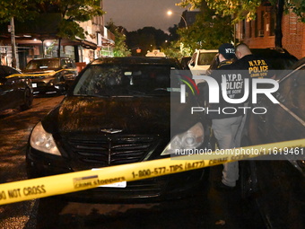 Evidence markers mark the scene where one man is killed and one man is injured in a shooting in the Kingsbridge Heights section of the Bronx...