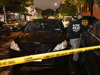 Evidence markers mark the scene where one man is killed and one man is injured in a shooting in the Kingsbridge Heights section of the Bronx...