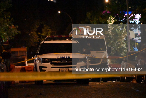 Evidence markers mark the scene where one man is killed and one man is injured in a shooting in the Kingsbridge Heights section of the Bronx...