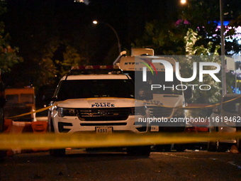 Evidence markers mark the scene where one man is killed and one man is injured in a shooting in the Kingsbridge Heights section of the Bronx...