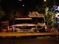 Evidence markers mark the scene where one man is killed and one man is injured in a shooting in the Kingsbridge Heights section of the Bronx...