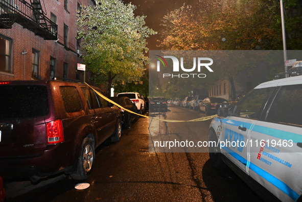 Evidence markers mark the scene where one man is killed and one man is injured in a shooting in the Kingsbridge Heights section of the Bronx...