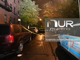 Evidence markers mark the scene where one man is killed and one man is injured in a shooting in the Kingsbridge Heights section of the Bronx...