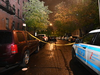 Evidence markers mark the scene where one man is killed and one man is injured in a shooting in the Kingsbridge Heights section of the Bronx...