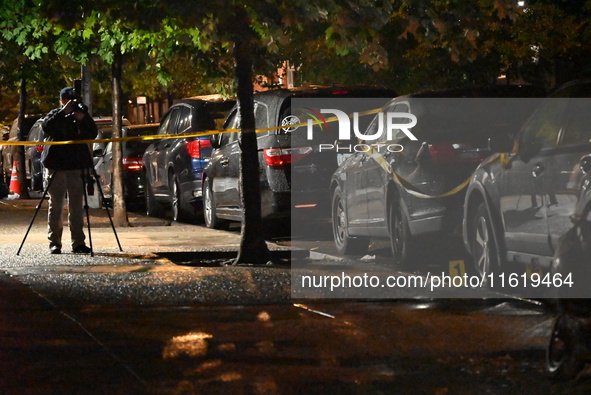 Evidence markers mark the scene where one man is killed and one man is injured in a shooting in the Kingsbridge Heights section of the Bronx...