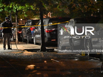 Evidence markers mark the scene where one man is killed and one man is injured in a shooting in the Kingsbridge Heights section of the Bronx...