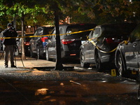 Evidence markers mark the scene where one man is killed and one man is injured in a shooting in the Kingsbridge Heights section of the Bronx...