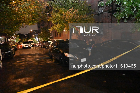 Evidence markers mark the scene where one man is killed and one man is injured in a shooting in the Kingsbridge Heights section of the Bronx...