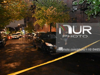 Evidence markers mark the scene where one man is killed and one man is injured in a shooting in the Kingsbridge Heights section of the Bronx...