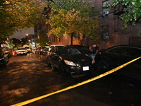 Evidence markers mark the scene where one man is killed and one man is injured in a shooting in the Kingsbridge Heights section of the Bronx...