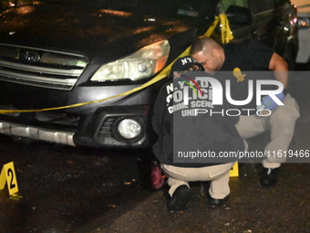 Evidence markers mark the scene where one man is killed and one man is injured in a shooting in the Kingsbridge Heights section of the Bronx...