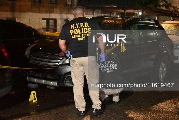 Evidence markers mark the scene where one man is killed and one man is injured in a shooting in the Kingsbridge Heights section of the Bronx...