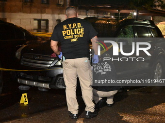 Evidence markers mark the scene where one man is killed and one man is injured in a shooting in the Kingsbridge Heights section of the Bronx...