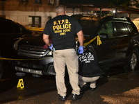 Evidence markers mark the scene where one man is killed and one man is injured in a shooting in the Kingsbridge Heights section of the Bronx...