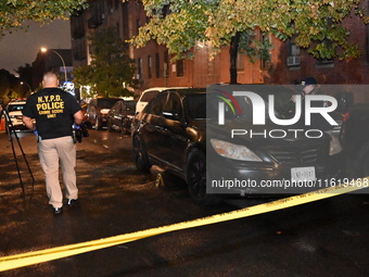 Evidence markers mark the scene where one man is killed and one man is injured in a shooting in the Kingsbridge Heights section of the Bronx...