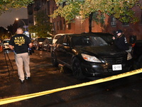 Evidence markers mark the scene where one man is killed and one man is injured in a shooting in the Kingsbridge Heights section of the Bronx...