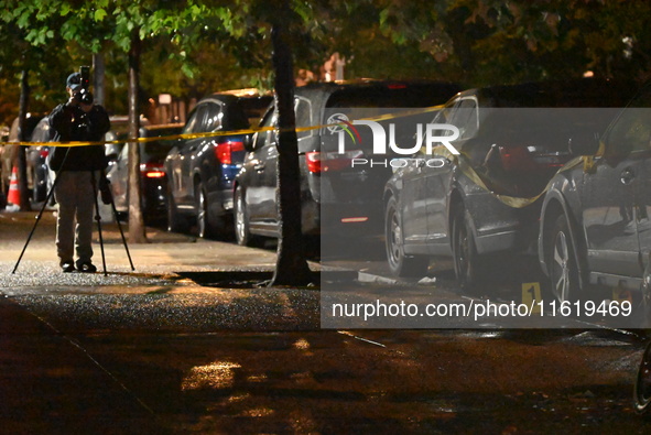 Evidence markers mark the scene where one man is killed and one man is injured in a shooting in the Kingsbridge Heights section of the Bronx...