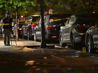 Evidence markers mark the scene where one man is killed and one man is injured in a shooting in the Kingsbridge Heights section of the Bronx...