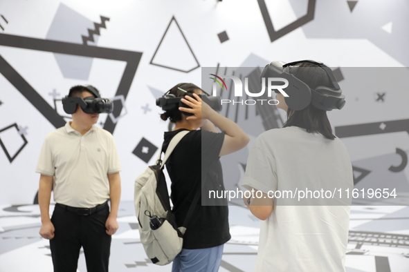 Visitors bring VR devices to experience the Digital Zhongshan Experience Museum in Nanjing, China, on September 29, 2024. 